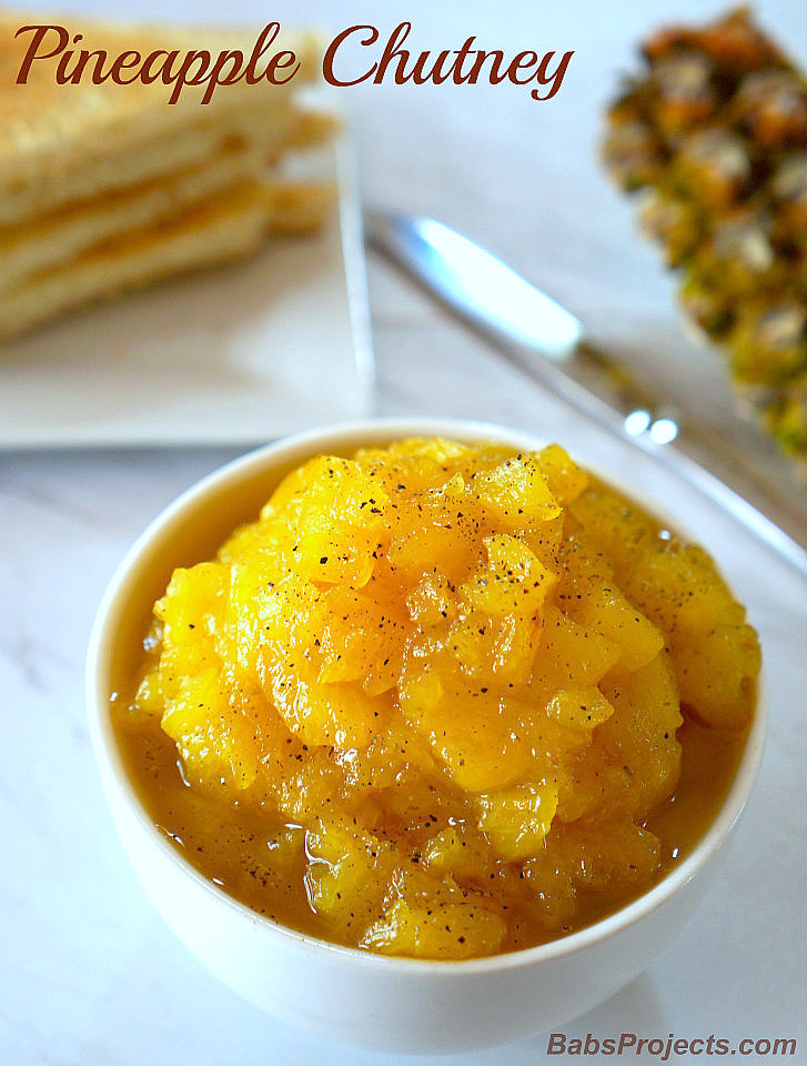 Pineapple Chutney in a White bowl with Toasts and a Knife