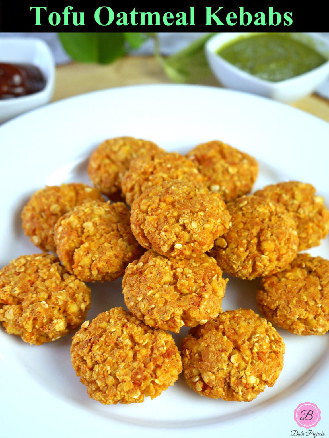 Tofu Oatmeal Kebabs on a White Plate with Green Chutney and Ketchup on the Side