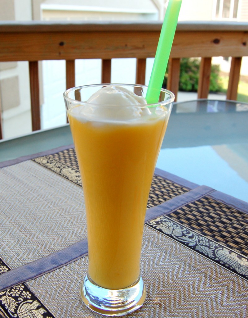 Mango Milkshake in a Tall Glass with Green Straw