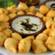 Vadas on a White Plate with Coconut Chutney in the Center