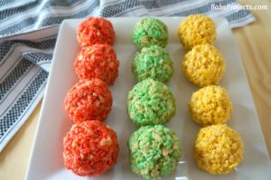 Rice Krispie Ladoo in Different Colors on a White Platter