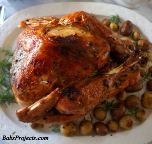 Herb Roasted Turkey on a Platter with Roasted Potatoes on the Side