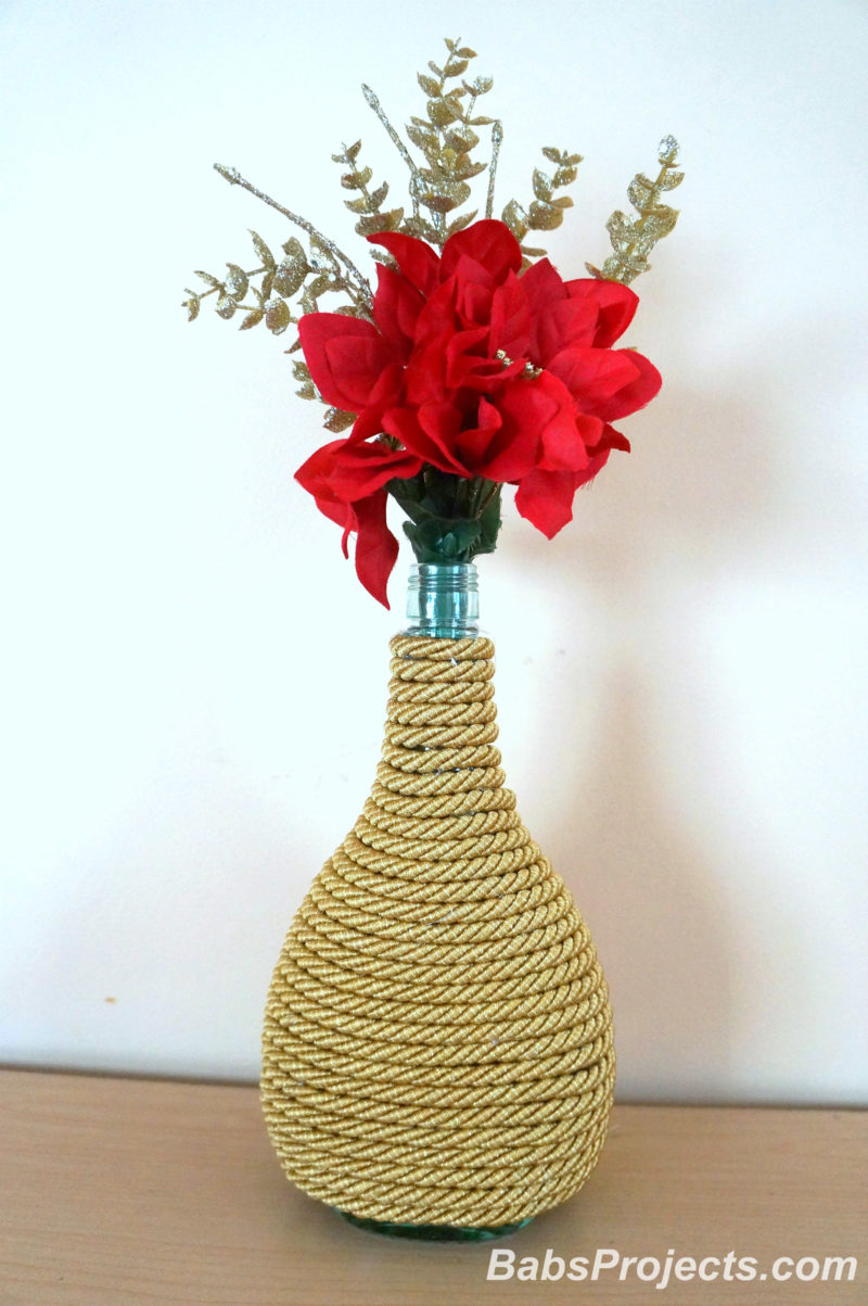 Decorative Cord Wrapped Christmas Vases with Golden Cord, Red and Golden Flowers Around Wine Bottle
