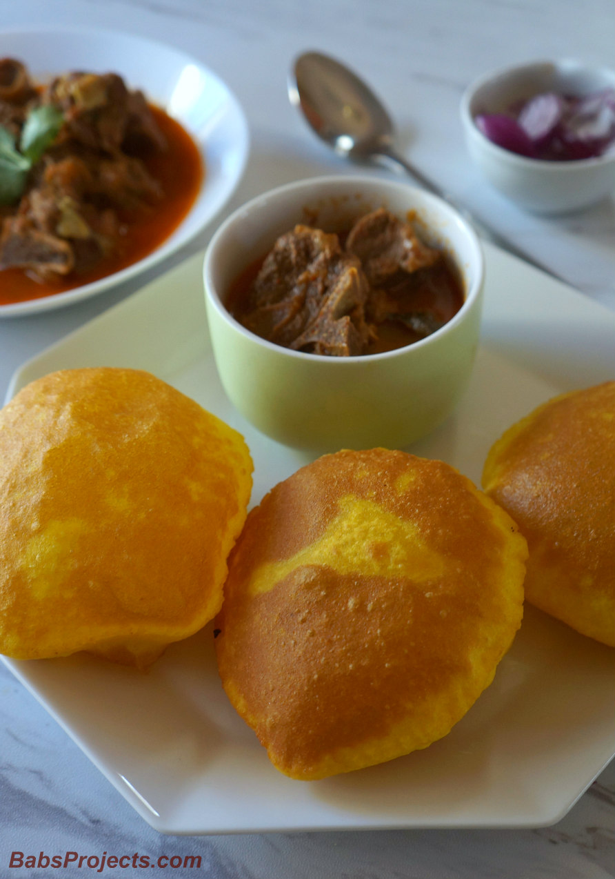 Rice Vade on a Plate with Mutton Curry and Some Onions on the Side