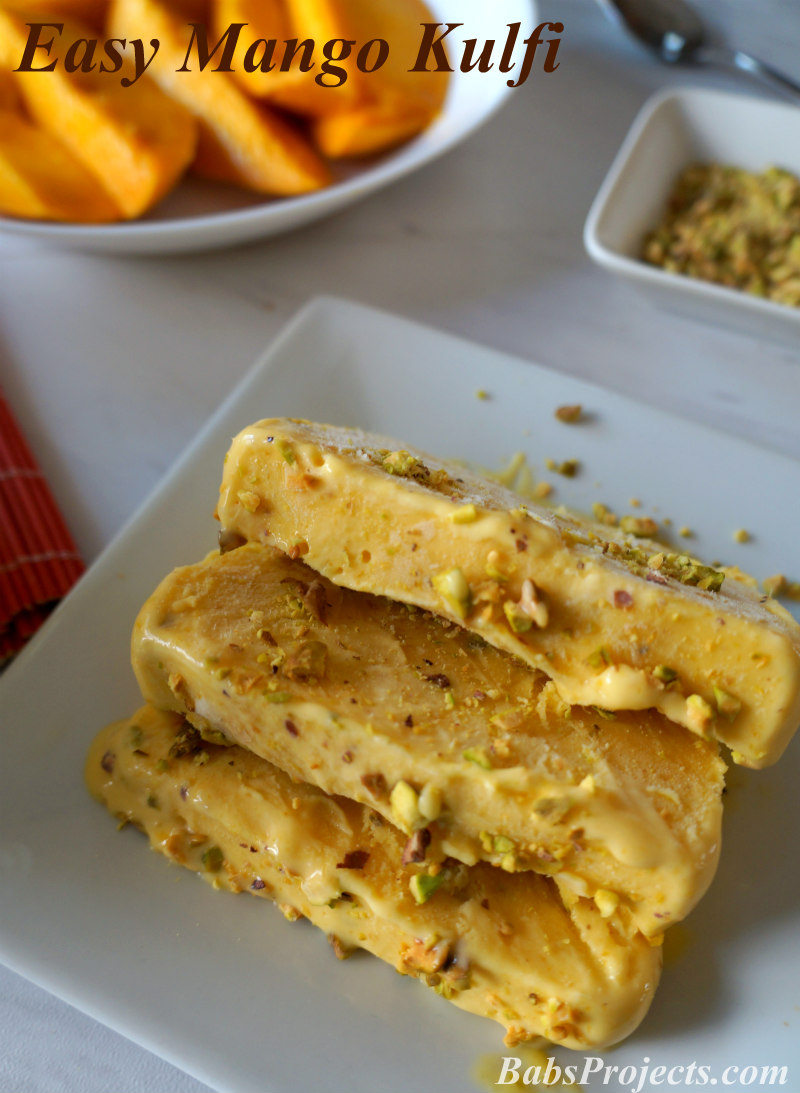 Mango Kulfi Slices with Fresh Mangoes on a White Plate