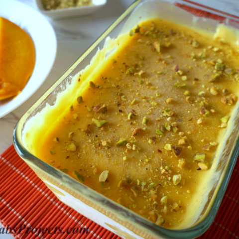 Mango Kulfi (Ice Cream) in a Glass Baking Pan on Top of a Red Placemat