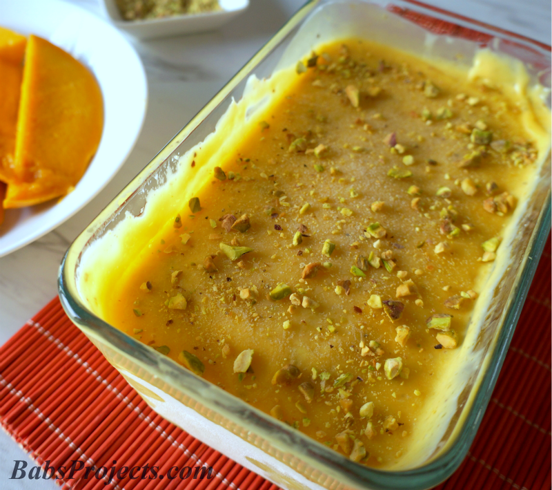 Mango Kulfi (Ice Cream) in a Glass Baking Pan on Top of a Red Placemat