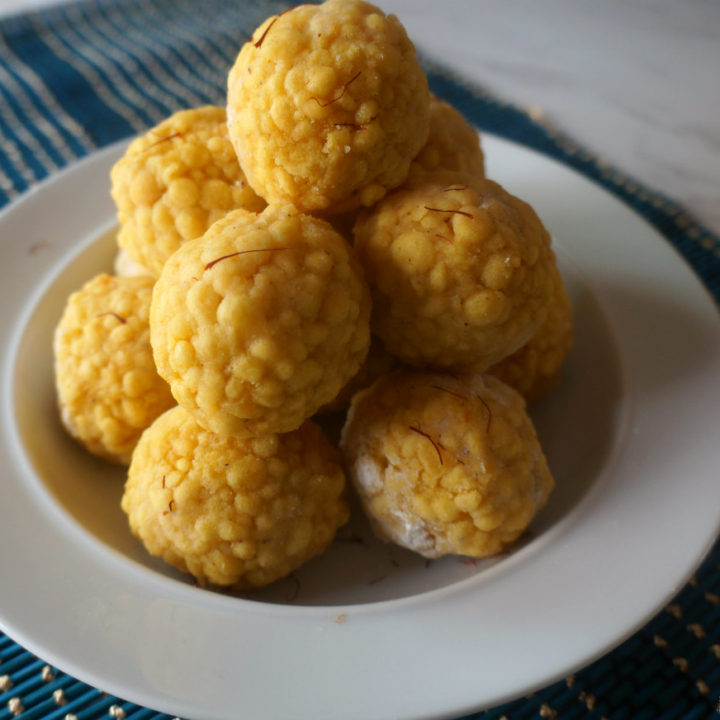 Boondi Ladoos on a While Bowl with Dark Blue Placemat