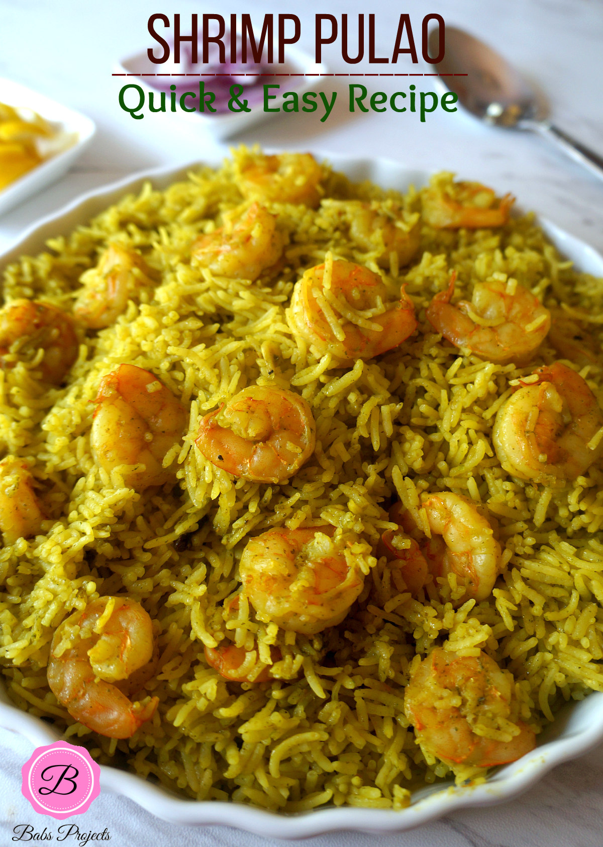 Green Masal Shrimp Pulao in a Pie Platter with Serving Spoon on the Side