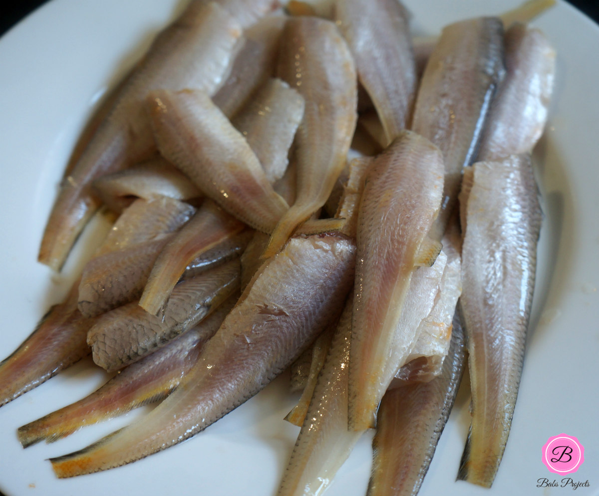 Cleaned Maneli, Golden Anchovies on a White Plate