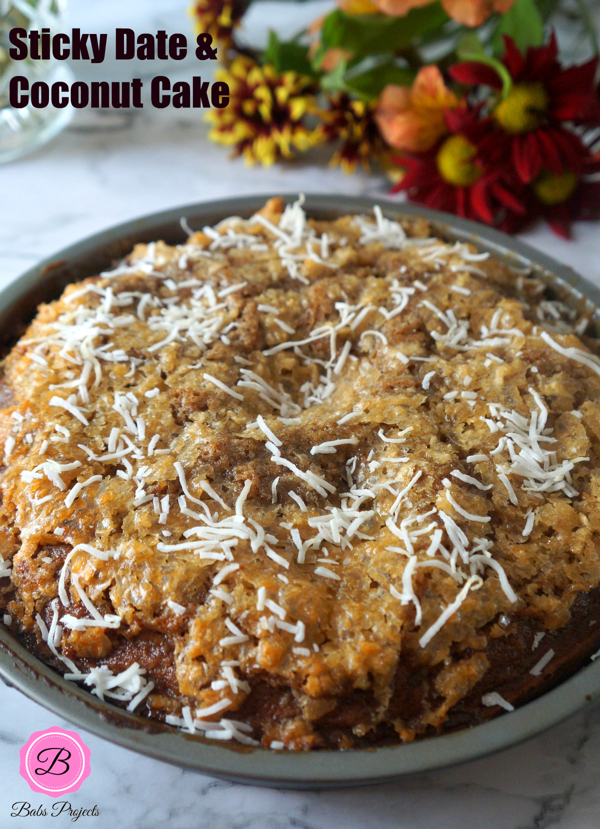 Sticky Date Coconut Cake in a Baking Pan and Flowers on the side
