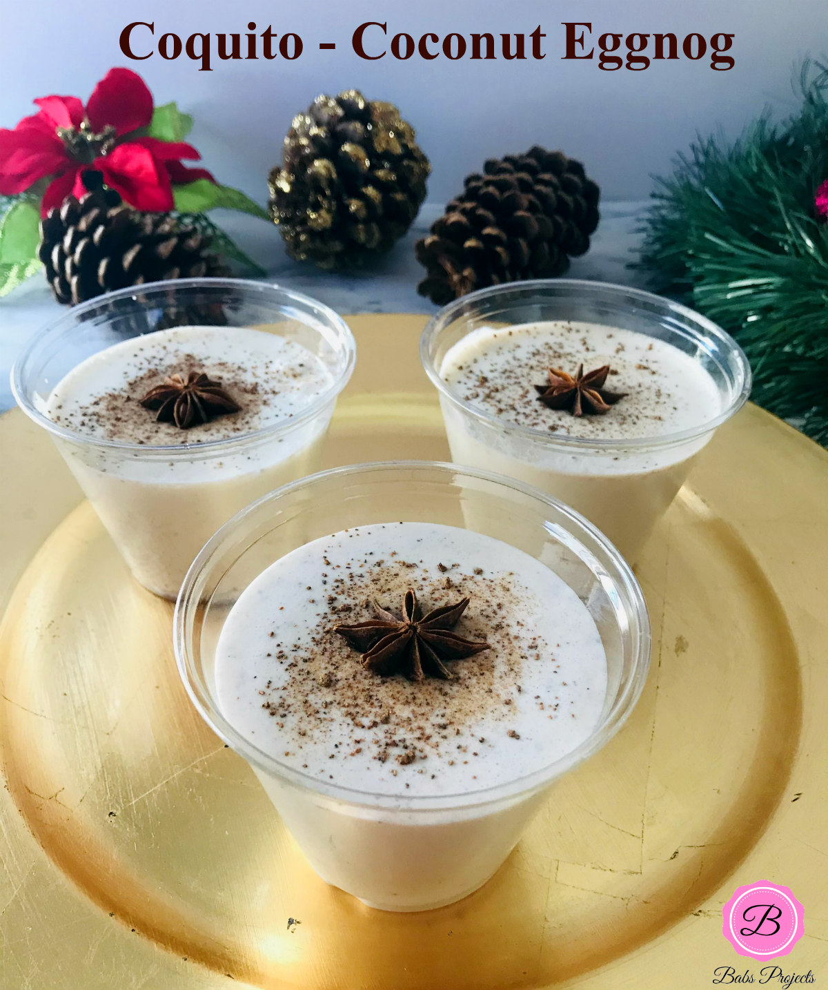 Three Glasses of Eggless Coquito on a Gold Starter Plate Garnishes with Star Anise