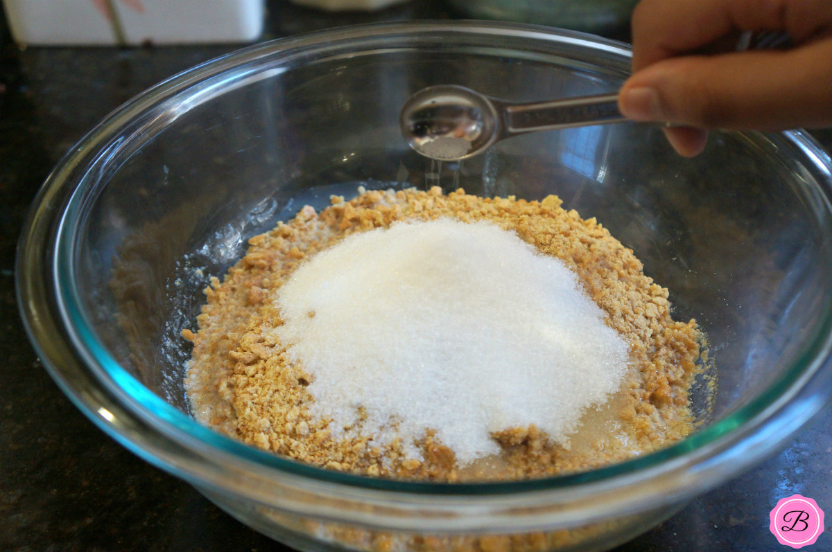 Ingredients for Graham Cracker Crust in a Glass Mixing Bowl
