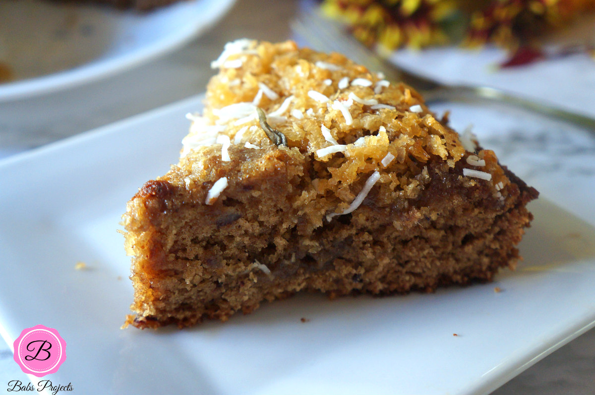 A Slice of Sticky Date Coconut Cake on a White Plate