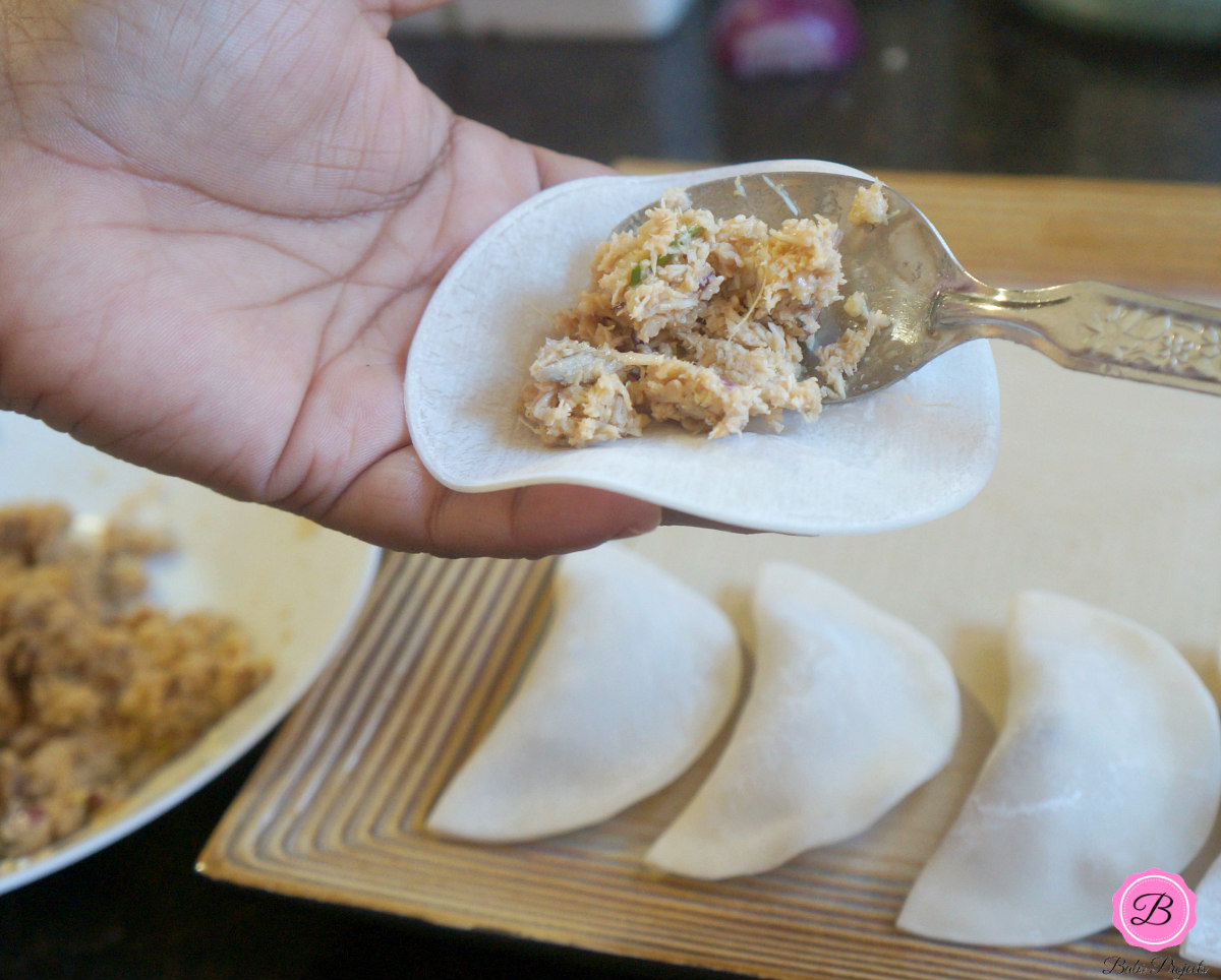 Turkey Stuffing Being Placed on a Dumpling Wrapper with a Spoon