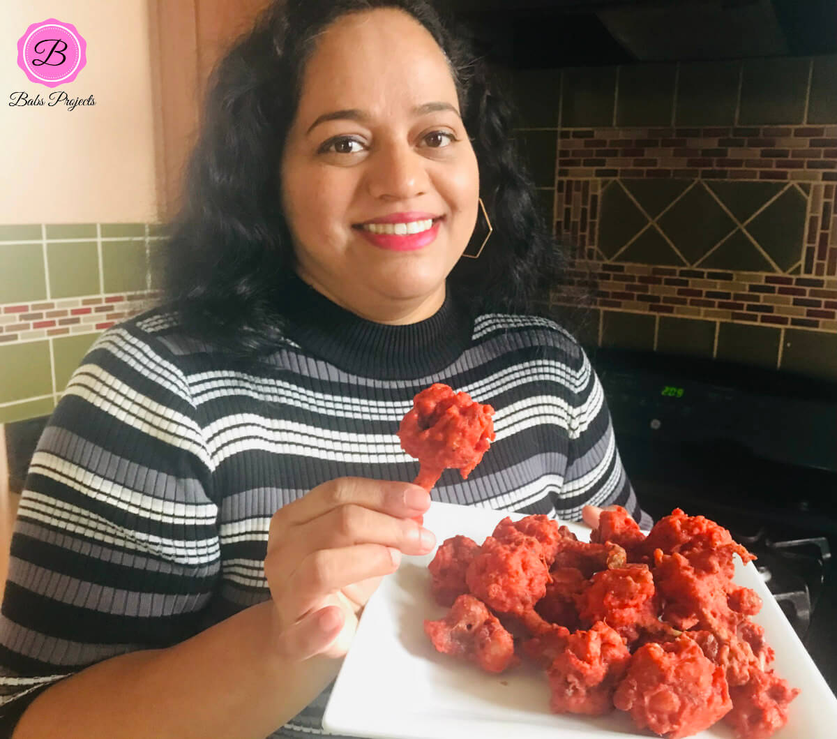 A Picture of Author Holding One Chicken Lollipop