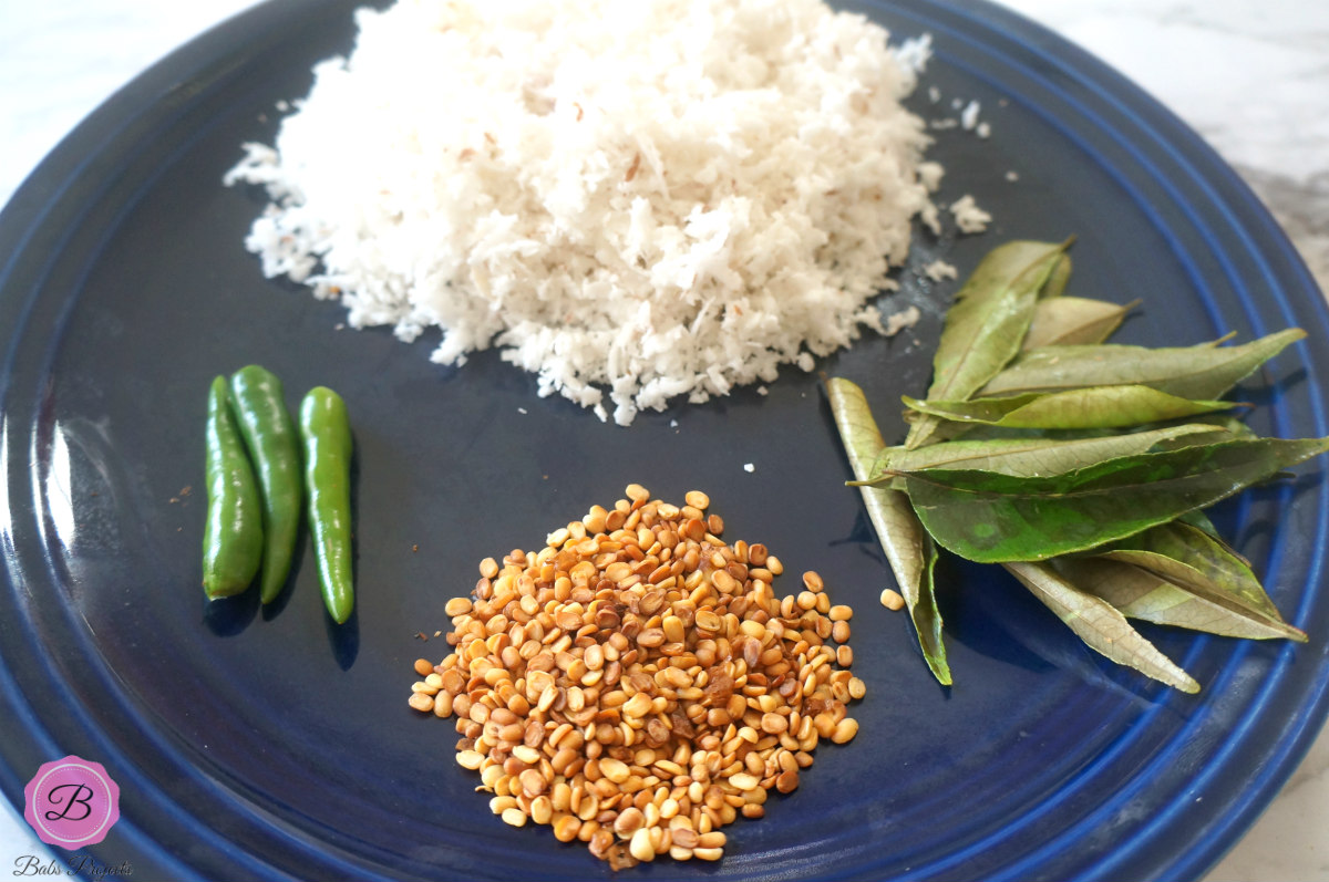 Coconut, Green Chilis, Urad Daal and Curry Leaves on a Blue Plate