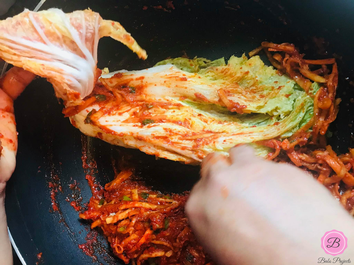 Applying Kimchi Mix on Napa Cabbage