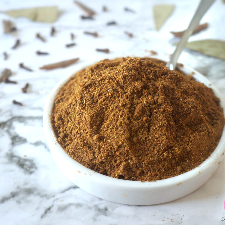 Garam Masala Powder in a White Bowl with Spoon