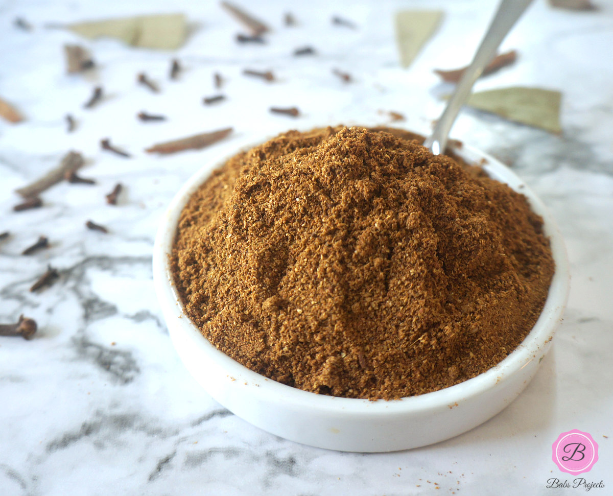 Garam Masala Powder in a White Bowl with Spoon