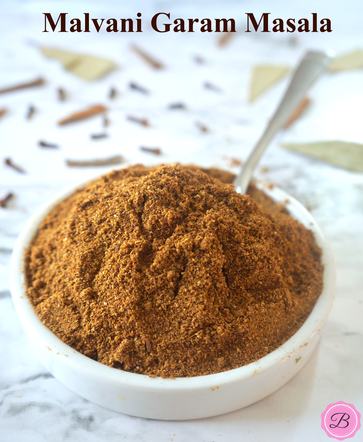 Malvani Garam Masala Powder in a White Bowl with a Spoon