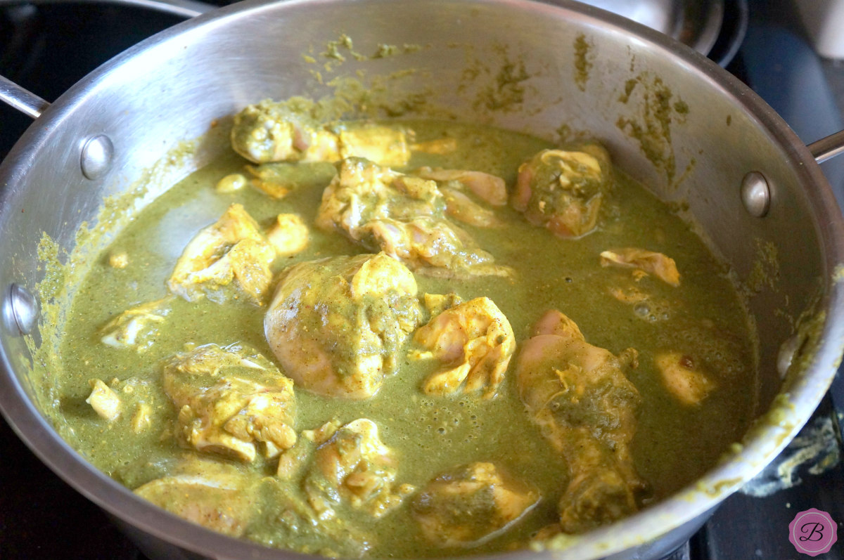 Chicken Being Cooked in Green Curry in a big Pot.