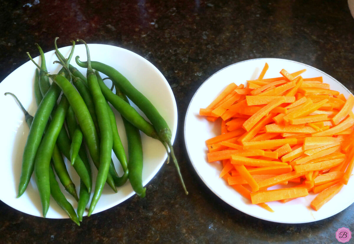 Long Green Chilis and Sliced Carrots in a White Bowl