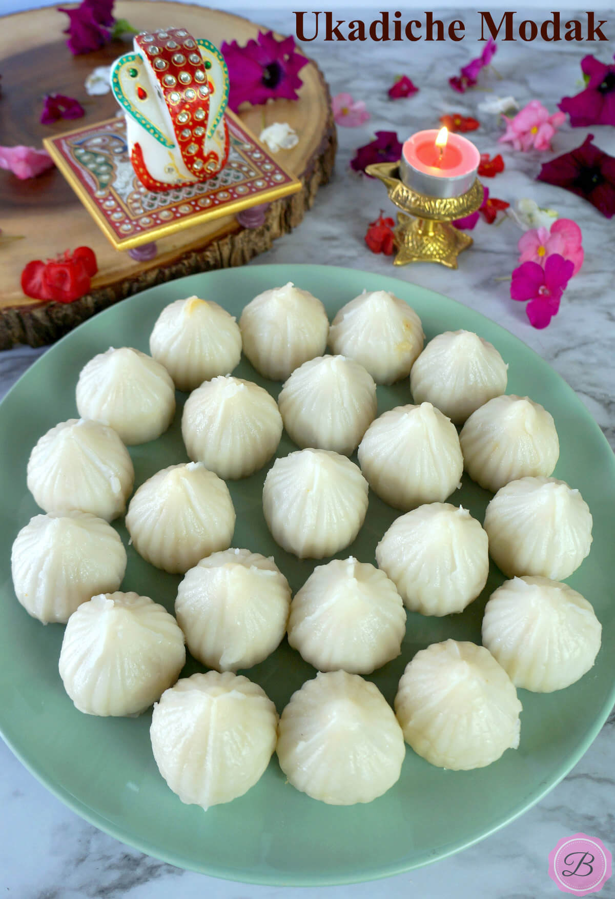 Ukadiche Modak on a Blue Plate with Ganesh Idol on the Side