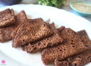 Raagi Neer Dosa Stacked on Top of Each Other on a White Platter