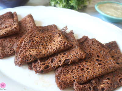 Raagi Neer Dosa Stacked on Top of Each Other on a White Platter