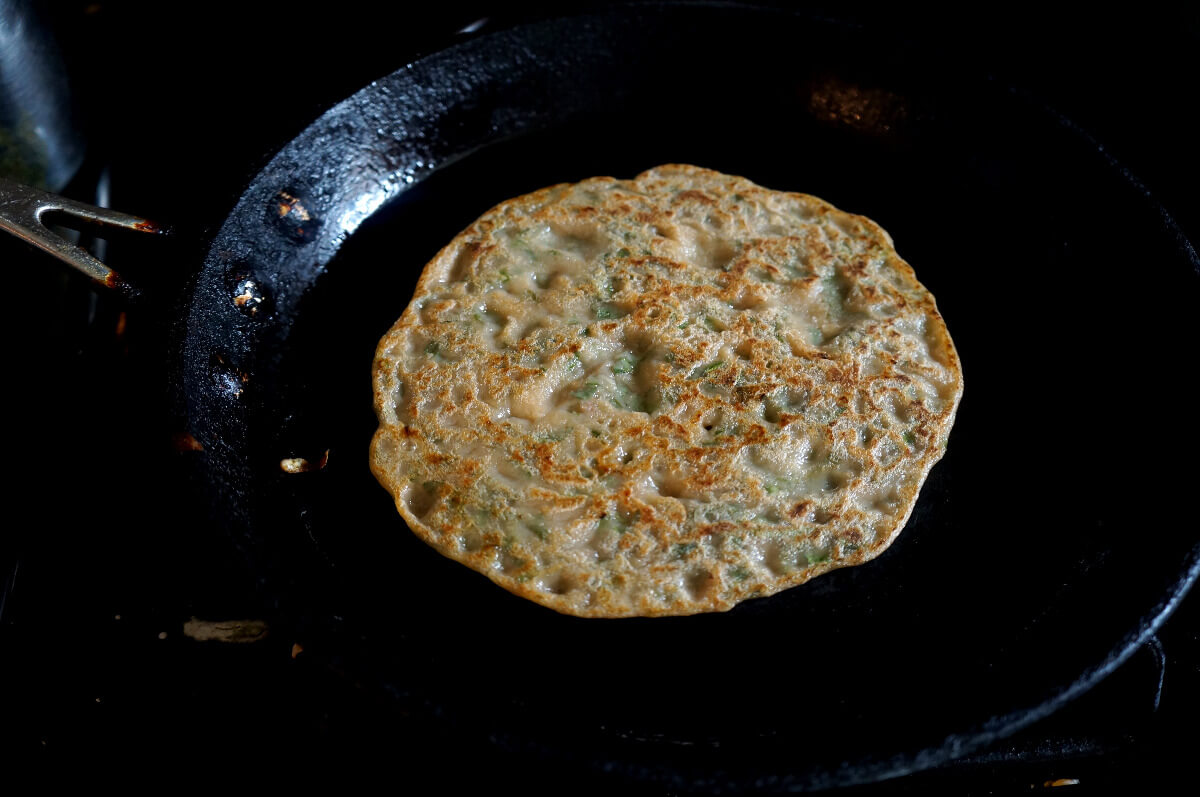 Colacasia Pancake cooking on a skillet