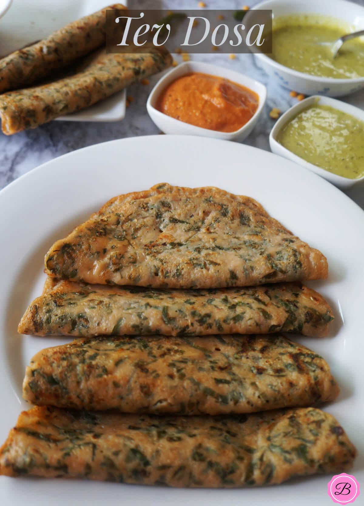 Tev Dosa on a White Plate with Red and Green Chutney on the Side