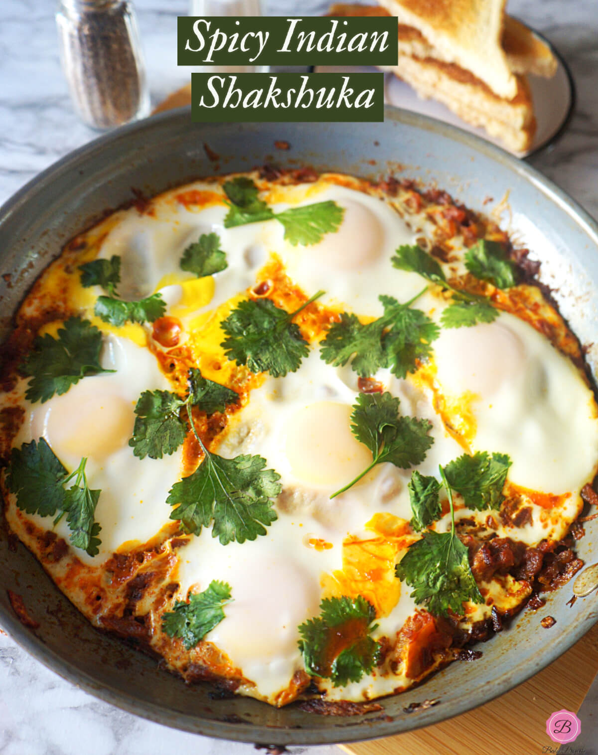 Spicy Indian Shakshuka cooked in a non-stick pan