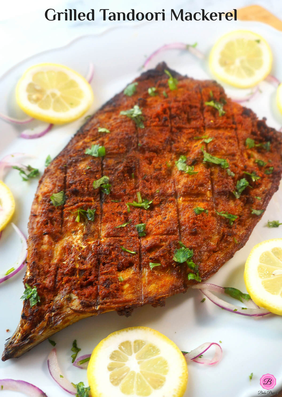 Tandoori Mackerel on a Platter with Lemon and Onion Slices