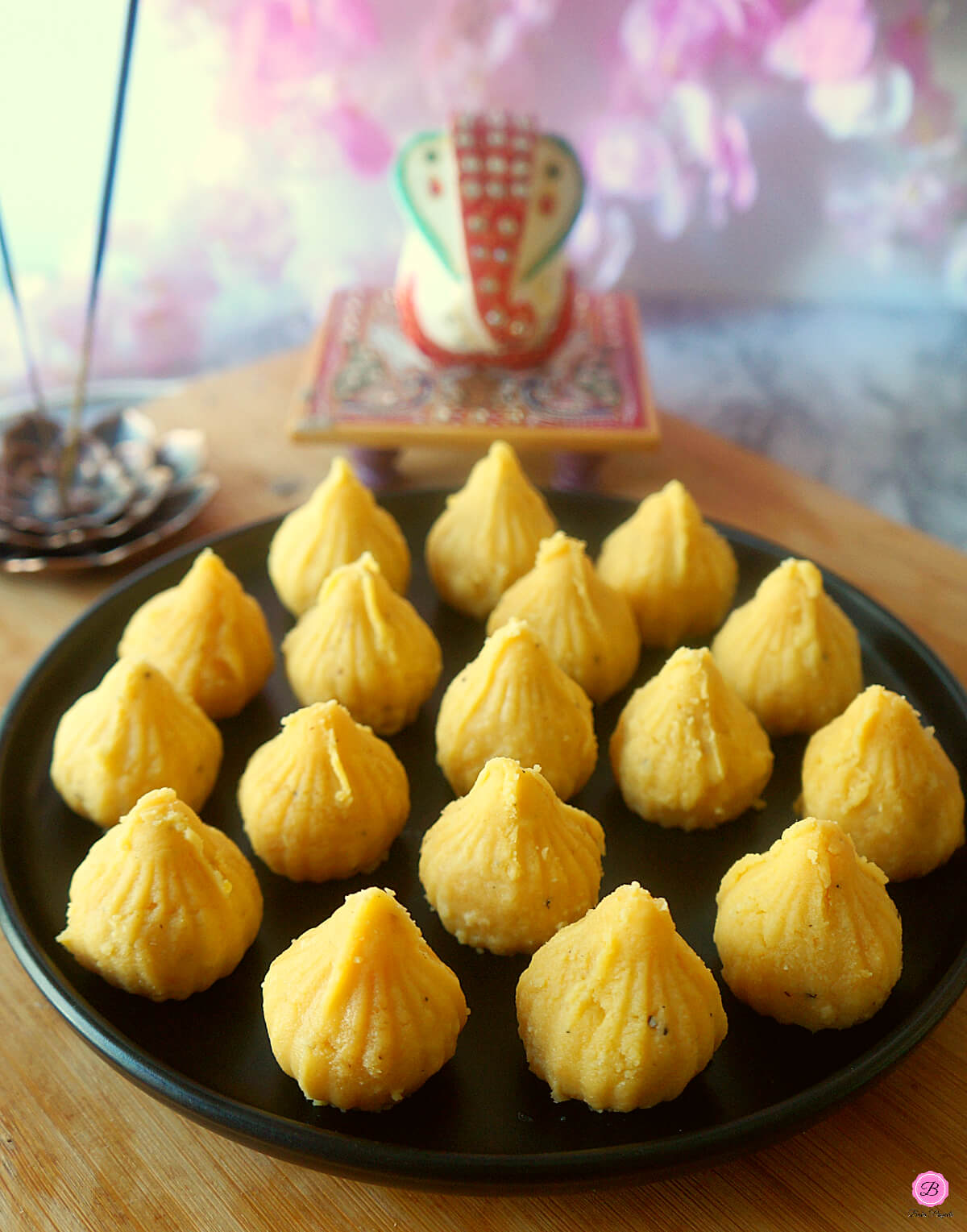 Mango Modak Peda on a Black Plate