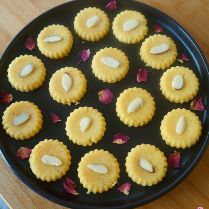 Mango Peda on a Black Platter Garnished with Rose Petals